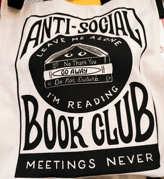 Photo of a book bag which reads: Anti-social Book Club. Leave me alone. Go away, I'm reading. Meetings never.